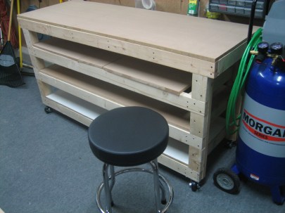 Here's a closeup. Notice the two extra shelves? That should be nice to store some airplane parts. Also, take note of the $20 swivel stool purchased from Northern Tool. I couldn't resist. Sorry. Also, please forgive the top shelf. I ran out of MDF, so I had to put the scrap pieces there for the sake of the picture. Again, please accept my apologies.