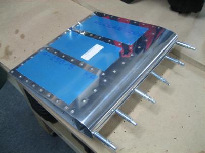 After the skins were riveted to the ribs and the trailing edge wedge, I rolled the leading edge and clecloed it together. I haven't edge formed the top skin yet, hence the ripples.